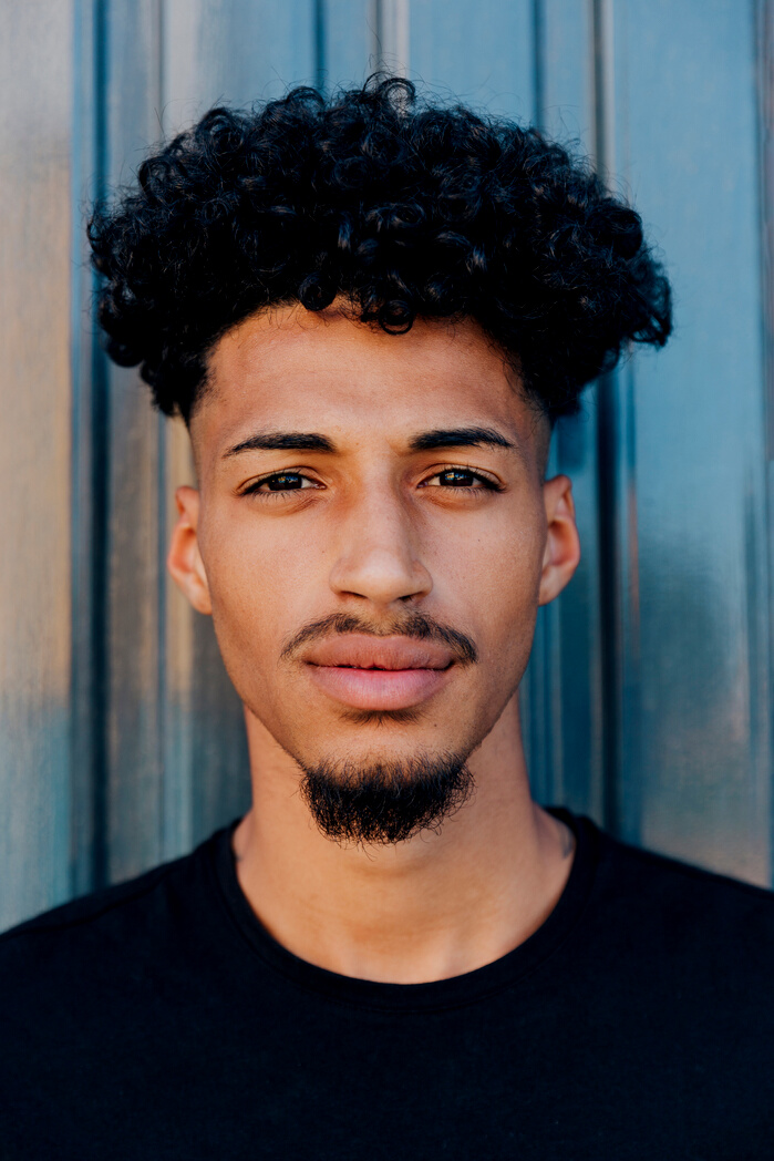 confident ethnic man with curly hair